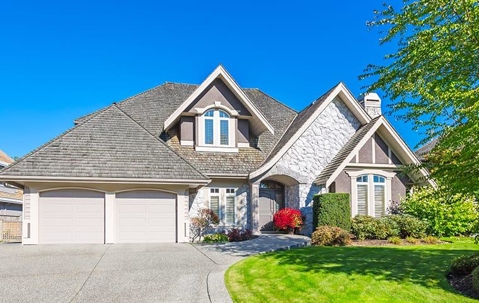 two story home with green grass